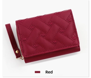 Detail of red PU leather tri-fold wallet with heart embroidery and wrist strap