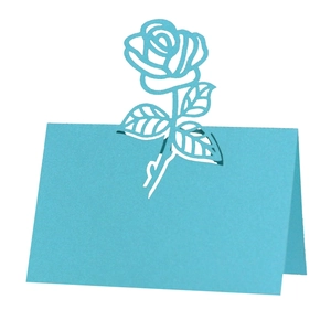 Detailed laser-cut rose design on teal blue wedding place card with a folded structure