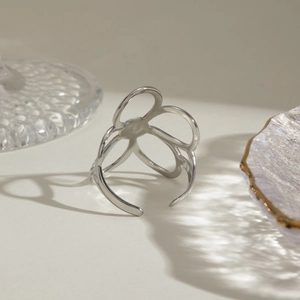Detailed macro view of an open-size silver flower ring with hollow oval petals design