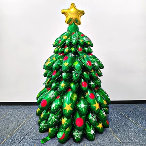 Detail of green Christmas tree foil balloon with gold star and snowflake prints