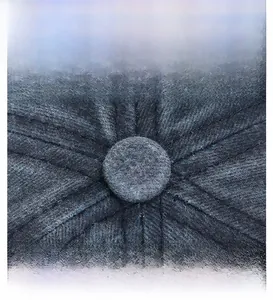 Detailed macro view of the top button and radial stitching on this cotton docker cap