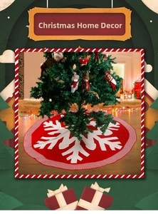 Close-up of red knitted Christmas tree skirt with white snowflake patterns and striped edges