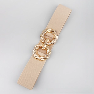 Detailed shot of beige elastic belt featuring a textured golden double-ring buckle