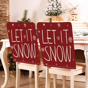Festive red Christmas chair covers with Let It Snow text and snowflakes in a cozy room