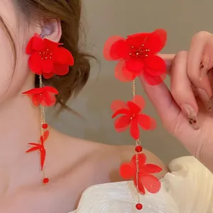 Long red fabric flower tassel earrings with golden chains and translucent petals
