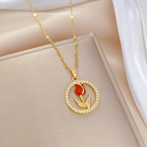Elegant gold titanium steel necklace featuring a red tulip pendant with zircon crystals