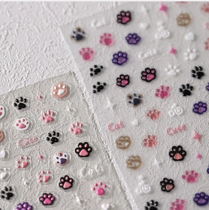 Macro view of 3D embossed cat paw nail stickers with cute heart and star patterns