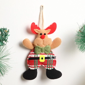 Handmade fabric reindeer Christmas tree ornament with green bow tie on a white wall