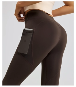 Detail view of high waist yoga leggings in dark brown with side mesh phone pocket feature