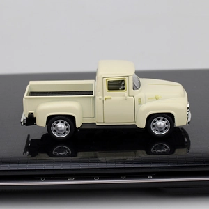 Side view of beige vintage pickup truck model toy on a glossy black reflective surface