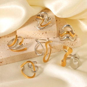 Irregular geometric wave rings in gold and silver finish on a luxury stone base