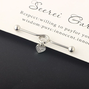 Detail of silver industrial barbell with twisted bar and sparkling zircon heart pendant