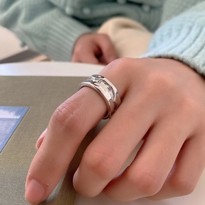 Detailed view of 925 sterling silver irregular hammer textured ring on finger