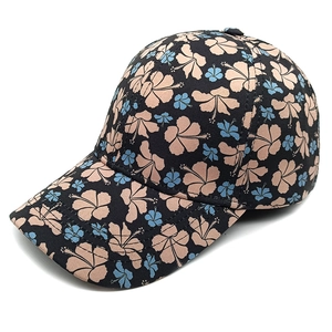 Detail of floral baseball cap showing pink hibiscus print and six-panel stitching