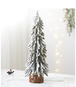 Mini PE snow flocked Christmas tree detail with a natural wood base for desktop decor