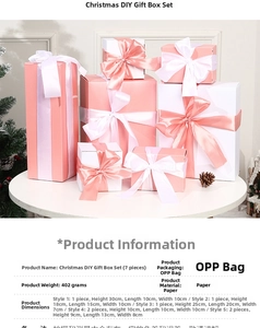 Detail of seven pink and white Christmas gift boxes with satin bows on a white table
