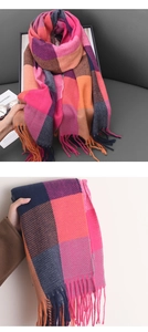 Close-up of pink and orange plaid cashmere-like scarf with thick fringe tassels