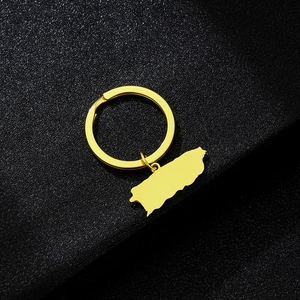 Detail of a golden Puerto Rico map pendant keychain made of polished stainless steel