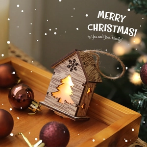 Lighted wooden Christmas house ornament with snowflake cutouts on rustic tray