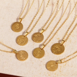 Detail of seven gold titanium steel necklaces with unique engraved floral oval pendants