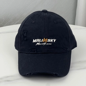 Close-up of black cotton baseball cap with MALINSKY 3D embroidery and distressed hole details