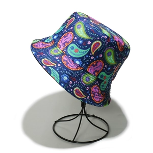 Detailed view of blue paisley bucket hat with colorful prints on a display stand