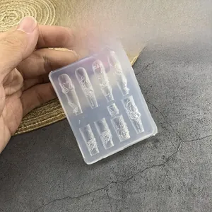 Detail of 3D embossed silicone nail art mold featuring swan and feather patterns