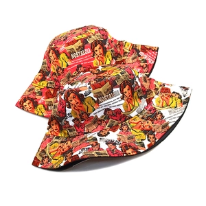 Close-up of dual-sided bucket hats with red vintage pop art comic prints and bold text