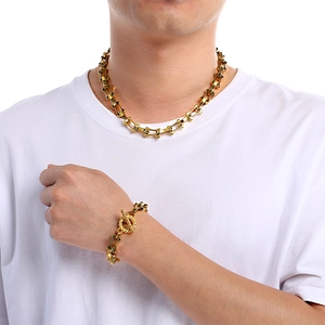 Men's gold titanium steel curved bamboo link bracelet with skull OT buckle detail