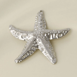 Macro view of textured 304 stainless steel starfish pendant with silver hammered finish