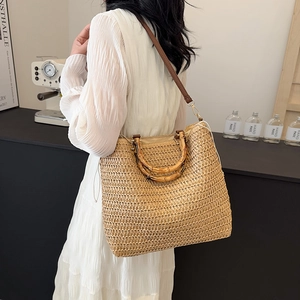 French straw tote bag with bamboo handles and leather strap for beach vacations