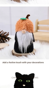 Close-up of Halloween plush gnome with orange pumpkin hat and black cat holiday ornaments