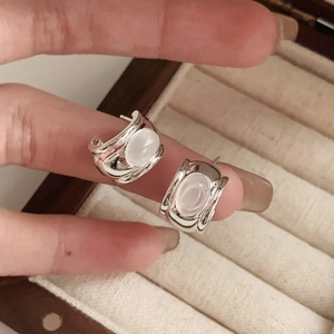 Minimalist 925 sterling silver stud earrings with oval translucent moonstone in hand