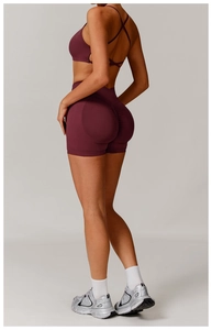 Close-up of the scrunch butt detail on high-waisted seamless fitness shorts in wine red