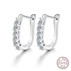 Detailed macro view of S925 sterling silver U-shaped earrings with sparkling cubic zirconia