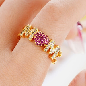 Close-up of a gold adjustable MOM ring with a pink heart and pave-set rhinestones