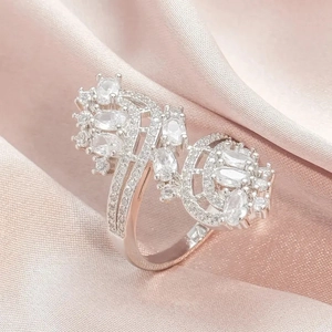 Close-up of luxury silver-plated ring with sparkling cubic zirconia on pink silk