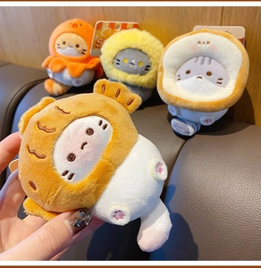 Close-up of cute plush cat keychain in taiyaki fish shape held by hand in detail