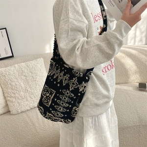 Detail view of fashion black and white geometric pattern plush shoulder bucket bag