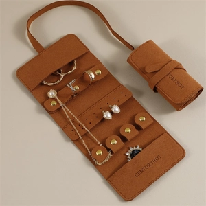 Caramel brown microfiber jewelry roll showing necklace hooks and ring storage slots