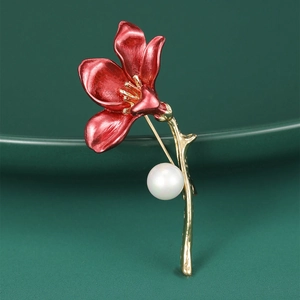 Detailed macro view of trumpet flower brooch with red enamel and white pearl accent