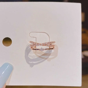 Detailed view of rose gold ring set featuring zircon accents on a white card tag