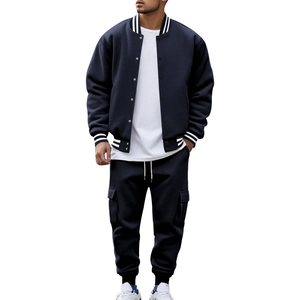 Detail of navy blue baseball jacket with striped collar and matching cargo pants
