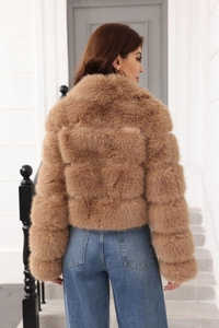 Rear view of a premium brown faux fur jacket with detailed texture on a model