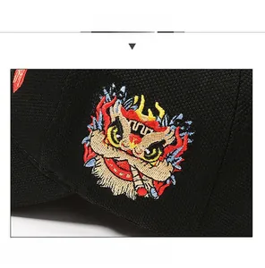 Macro detail of the Chinese guardian lion embroidery on this black baseball cap