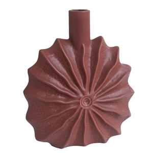 Minimalist terracotta ceramic sun flower vase with radial texture on white background