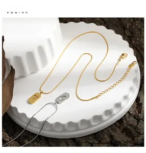 Macro detail of number 7 pendant on gold and silver snake chains with 18KGP engraving