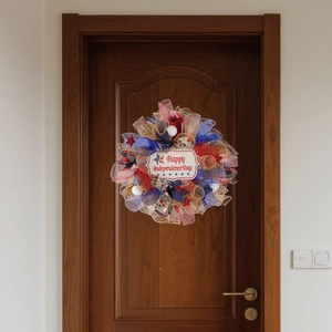 Patriotic Independence Day wreath with red blue white mesh and stars on a wooden door