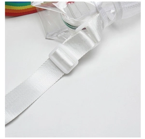Detail of white nylon webbing and adjustable plastic buckle on transparent PVC beach bag