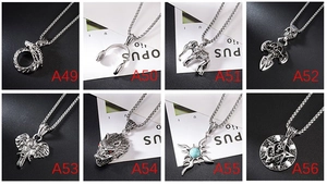 Detail of diverse gothic silver pendants featuring dragon, wolf head, and skull designs